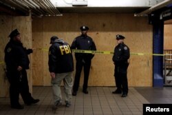 A member of the FBI enters the crime scene beneath the New York Port Authority Bus Terminal following an attempted detonation during the morning rush hour, in New York City, New York, Dec. 11, 2017.