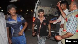 Men wounded by car bomb attack, Nasiriyah city, Iraq, Aug. 10, 2013.