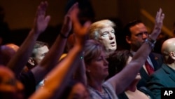 FILE- In this Oct. 30, 2016, file photo, Republican presidential candidate Donald Trump stands during a service at the International Church of Las Vegas in Las Vegas. President Trump’s pledge to scrap limits on church political activity could have sweeping effects that extend beyond his conservative supporters to more liberal congregations, including the black evangelical church that has long helped anchor the Democratic Party’s electoral machinery. 