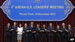 U.S. President Barack Obama, fifth from left, stands hand in hand with ASEAN leaders for a family photo during the ASEAN-U.S. leaders' meeting at the Peace Palace in Phnom Penh, Cambodia, Monday, Nov. 19, 2012. They are, from left, Philippines' President Benigno Aquino III, Singapore's Prime Minister Lee Hsien Loong, Thailand's Prime Minister Yingluck Shinawatra, Vietnam's Prime Minister Nguyen Tan Dung, Obama, Cambodia's Prime Minister Hun Sen, Brunei's Sultan Hassanal Bolkiah, Indonesia's President Susilo Bambang Yudhoyono, Laos Prime Minister Thongsing Thammavong, Malaysia's Prime Minister Najib Razak and Myanmar's President Thein Sein. (AP Photo/Carolyn Kaster)