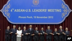 U.S. President Barack Obama, fifth from left, stands hand in hand with ASEAN leaders for a family photo during the ASEAN-U.S. leaders' meeting at the Peace Palace in Phnom Penh, Cambodia, Monday, Nov. 19, 2012. They are, from left, Philippines' President Benigno Aquino III, Singapore's Prime Minister Lee Hsien Loong, Thailand's Prime Minister Yingluck Shinawatra, Vietnam's Prime Minister Nguyen Tan Dung, Obama, Cambodia's Prime Minister Hun Sen, Brunei's Sultan Hassanal Bolkiah, Indonesia's President Susilo Bambang Yudhoyono, Laos Prime Minister Thongsing Thammavong, Malaysia's Prime Minister Najib Razak and Myanmar's President Thein Sein. (AP Photo/Carolyn Kaster)