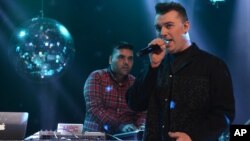 FILE - Naughty Boy and Sam Smith record 'La La La' for BBC 1's Christmas Day Special in London on Dec. 7, 2013. 