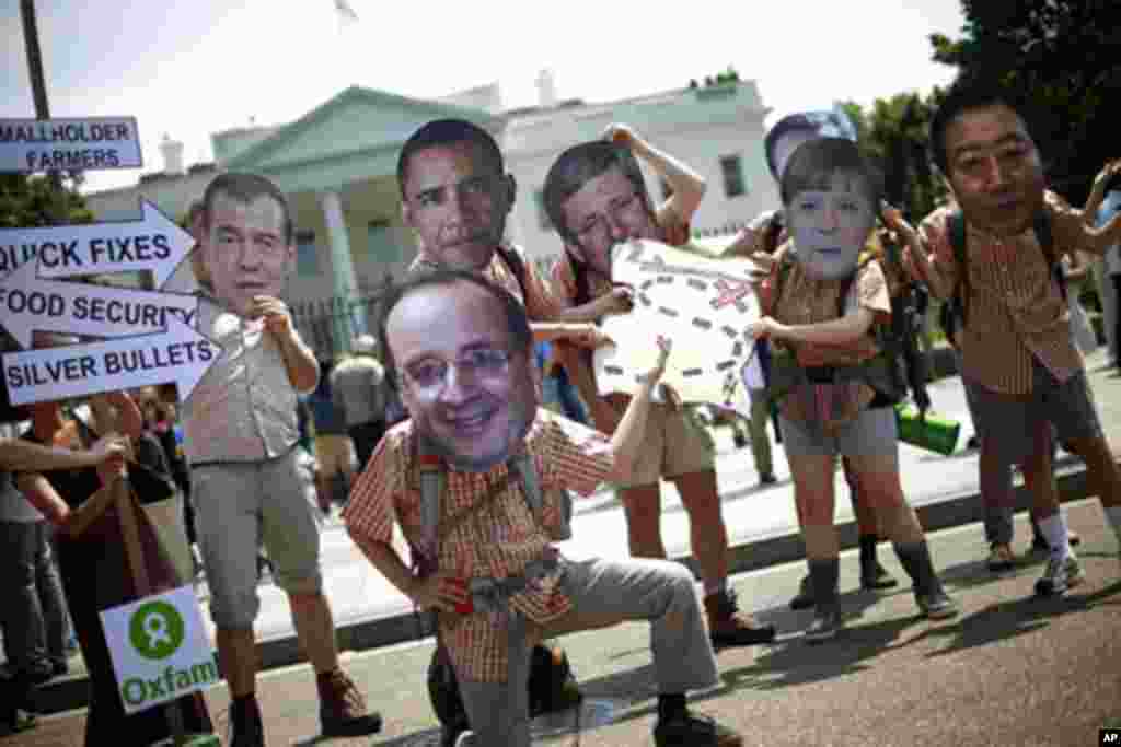Activists wearing masks depicting G8 world leaders participate in a demonstration outside the White House in Washington, May 17, 2012. (AP)