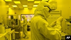 Researchers work in a clean room at the expanded University of Michigan Lurie Nanofabrication Facility in Ann Arbor, Michigan, April 10, 2008.