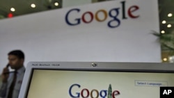 A security guard answers the phone at the reception counter of a Google office. (File Photo)