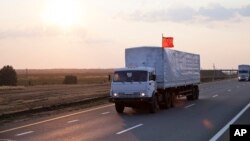 A convoy of white trucks carrying humanitarian aid passes along the main road M4 (Don highway) Voronezh region, Russia, Aug. 12, 2014