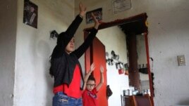 Marlene Beltran, 14, left, and her brother Felipe Beltran, 5, exercise during a gym class broadcast through Bacata Stereo radio station during the lockdown in Funza, Colombia, Wednesday, May 13, 2020.