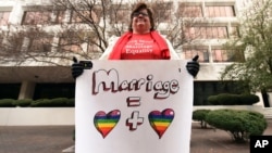Helen Barnes holds a sign of support for gay marriage outside the 5th U.S. Circuit Court of Appeals in New Orleans, Jan. 9, 2015.