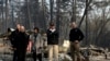 President Donald Trump talks with from left, Gov.-elect Gavin Newsom, California Gov. Jerry Brown, Paradise Mayor Jody Jones and FEMA Administrator Brock Longduring a visit to a neighborhood destroyed by the wildfires, Saturday, Nov. 17, 2018, in Paradise