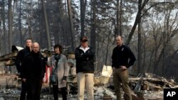 President Donald Trump talks with from left, Gov.-elect Gavin Newsom, California Gov. Jerry Brown, Paradise Mayor Jody Jones and FEMA Administrator Brock Longduring a visit to a neighborhood destroyed by the wildfires, Saturday, Nov. 17, 2018, in Paradise