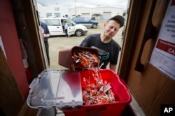 Chris Burkett deposits old needles for new ones at a needle exchange program run by the Grays Harbor County Public Health and Social Services Department in Aberdeen, Wash., June 14, 2017. The department last year collected 750,000 needles at its syringe exchange designed to stem the tide of disease, an incredible number for a small town, but still down from more than 900,000 the year before. They attribute that improvement to the methadone clinic that helps nearly 500 people stay off drugs.