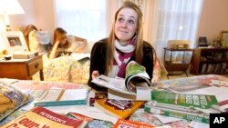 FILE - Kim Pollock, 17, facing center, goes through college materials, with the help of her sister Lindsay, 15, back left, in her bedroom in Bedford, N.H. 
