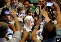 Pope Francis is surrounded as he arrives for a meeting at the San Jose school stadium in Asuncion, Paraguay on July 11, 2015.