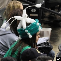 This woman sports a Fighting Sioux war bonnet, albeit one that’s not very fearsome.