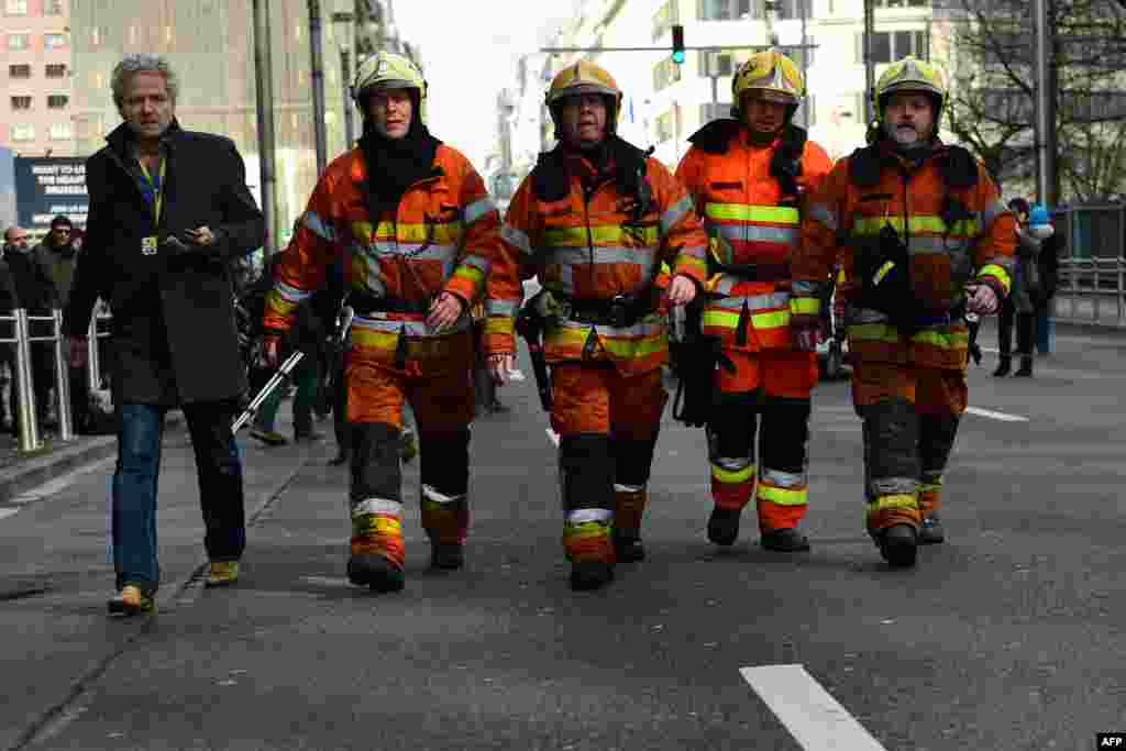 Firefighters arrive at the scene near Maalbeek metro station, on March 22, 2016 in Brussels, after a blast at this station near the EU institutions caused deaths and injuries. 