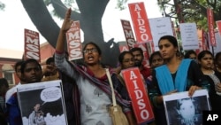 A member of a students organization shouts slogans as others carry placards asking justice for Asifa Mohammad Yusuf, an 8-year-old girl who was raped and murdered, during a protest in Bangalore, India, Friday, April 13, 2018. 