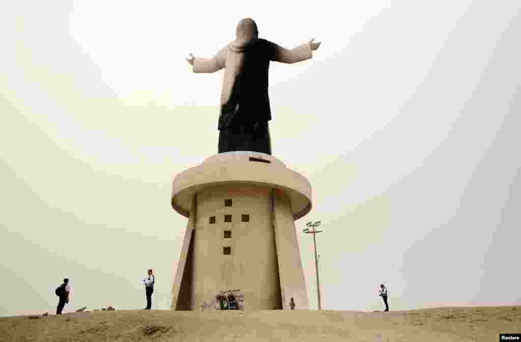 Police investigate near the statue of 'Christ of the Pacific' that was partially burned after a fire at the base of the monument, at Morro Solar hill in Chorrillos, Lima, Peru, Jan. 13, 2018.