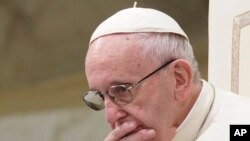 FILE - Pope Francis is caught in pensive mood during his weekly general audience at the Vatican, Aug. 22, 2018. 