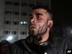 Dogan Asik, 28, who was blown away from inside a bus by a powerful explosion, speaks at the explosion site in the busy center of Turkish capital, Ankara, Turkey, March 13, 2016.
