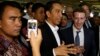 Indonesian President-elect Joko Widodo, center, speaks with Facebook CEO Mark Zuckerberg, right, during their visit to a market in Jakarta, Indonesia, Oct 13, 2014. 