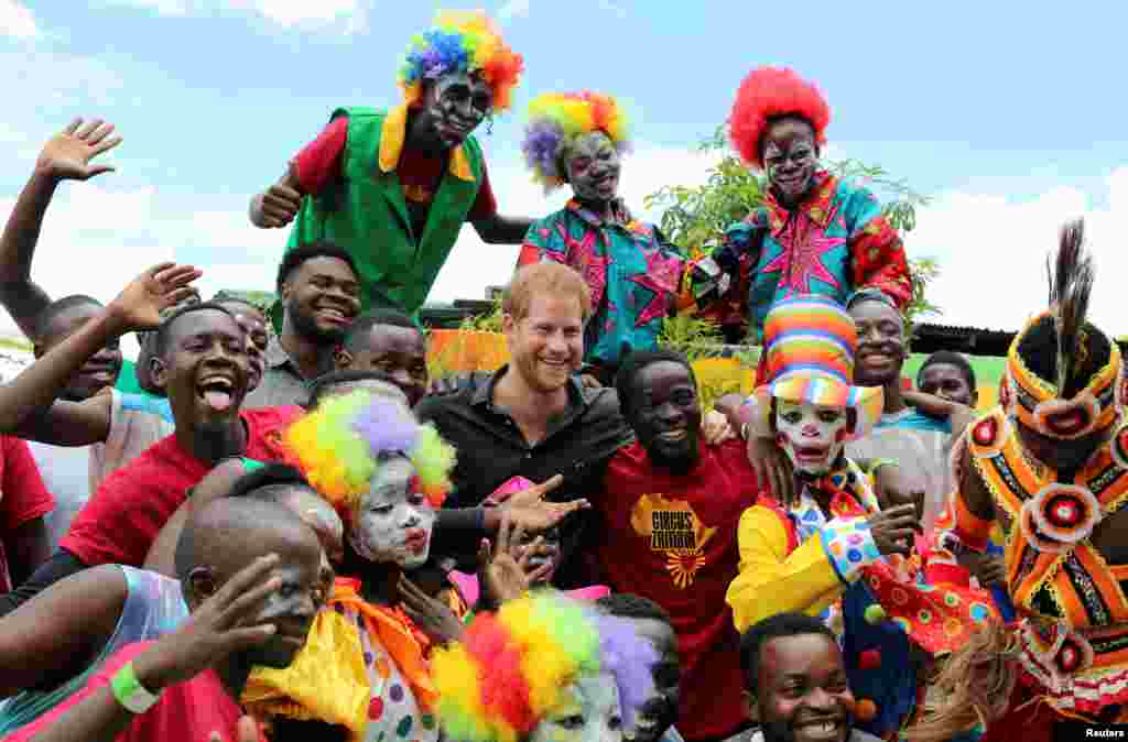 Youths pose for a photograph with Britain&#39;s Prince Harry during his visit to Circus Zambia in Lusaka.