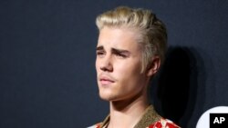 FILE - Justin Bieber arrives at Saint Laurent at the Palladium at the Hollywood Palladium in Los Angeles, Feb. 10, 2016.