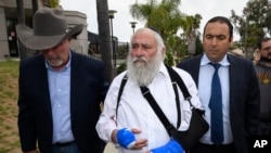 Rabbi Yisroel Goldstein, center, arrives for a news conference at the Chabad of Poway synagogue, April 28, 2019, in Poway, California. 