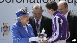 Britain's Queen Elizabeth II presents the trophy to the winning jockey of the Diamond Jubilee Coronation Cup race, June 2, 2012