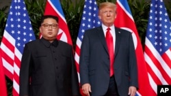 FILE - U.S. President Donald Trump, right, meets with North Korean leader Kim Jong Un on Sentosa Island, in Singapore, June. 12, 2018. 