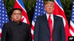 FILE - U.S. President Donald Trump, right, meets with North Korean leader Kim Jong Un on Sentosa Island, in Singapore, June. 12, 2018.