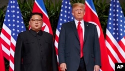 FILE - U.S. President Donald Trump is shown with North Korea's Kim Jong Un on Sentosa Island, in Singapore, June. 12, 2018. 