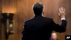 Supreme Court nominee Judge Brett Kavanaugh is sworn in by Chairman Chuck Grassley, R-Iowa, before testifying during the Senate Judiciary Committee, Sept. 27, 2018 on Capitol Hill in Washington. 