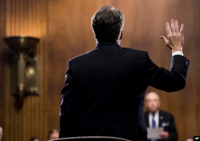 Supreme Court nominee Judge Brett Kavanaugh is sworn in by Chairman Chuck Grassley, R-Iowa, before testifying during the Senate Judiciary Committee, Sept. 27, 2018 on Capitol Hill in Washington.