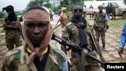 FILE - Seleka fighters at their base before a mission in the town of Lioto, Central African Republic, June 9, 2014.