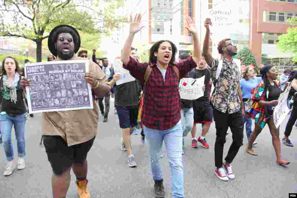 Baltimore students hold their hands up symbolically in a massive march against police brutality and discrimination. April 30, 2015. (Victoria Macchi/VOA News)