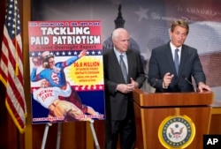 Senators John McCain, left, and Jeff Flake talk to reporters about “paid patriotism” during a news conference on Capitol Hill in Washington, Nov. 4, 2015.
