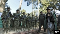 Ashraf Ghani Ahmadzai (R), head of the Transition Commission, inspects an Afghan military guard during a ceremony to hand over security control in Qala Naw, center of Badghis province. (file)