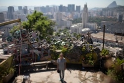 In this Jan.7, 2020 photo, Ale Roque poses for a photo at the Yellow House cultural center in Rio's first favela Morro da Providencia, Rio de Janeiro, Brazil. I want to make the world green!" she says and laughs, then collects herself. "It's because someone has to do it, truthfully that's it. Someone has to do it," Roque said. (AP Photo/Silvia Izquierdo)
