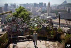 In this Jan.7, 2020 photo, Ale Roque poses for a photo at the Yellow House cultural center in Rio's first favela Morro da Providencia, Rio de Janeiro, Brazil. I want to make the world green!" she says and laughs, then collects herself. "It's because someone has to do it, truthfully that's it. Someone has to do it," Roque said. (AP Photo/Silvia Izquierdo)