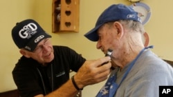 FILE -- Caregiver Warren Manchess, 74, left, shaves Paul Gregoline, 92, in Noblesville, Indiana. The share of the U.S. population over age 60 is expected to rise by 40 percent between 2010 and 2050.