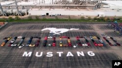 Photo provided by the Ford Motor Co., shows Mustang vehicles parked to spell out "10,000,000" on a parking lot at the Flat Rock Assembly plant, Aug. 8, in Flat Rock, Mich. 