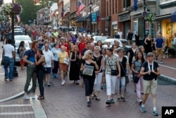 People walk in silence during a vigil in response to a shooting in the Capital Gazette newsroom, June 29, 2018, in Annapolis, Md.