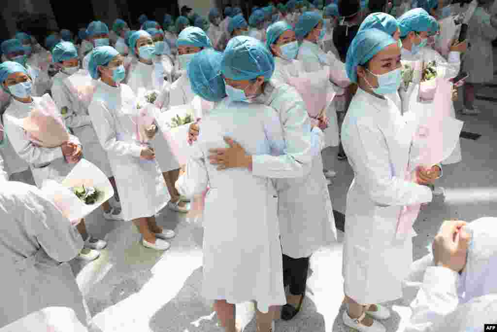 Nurses embrace during a ceremony marking International Nurses Day, at Tongji Hospital in Wuhan, in China&#39;s central Hubei province.