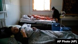 Coronavirus patients lie in an infectious diseases clinic in Stepanakert in the separatist region of Nagorno-Karabakh, Tuesday, Oct. 20, 2020.