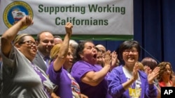 Union workers support California Gov. Jerry Brown signing a bill creating highest statewide minimum wage at $15 an hour by 2022 at the Ronald Reagan building in Los Angeles, April 4, 2016. 