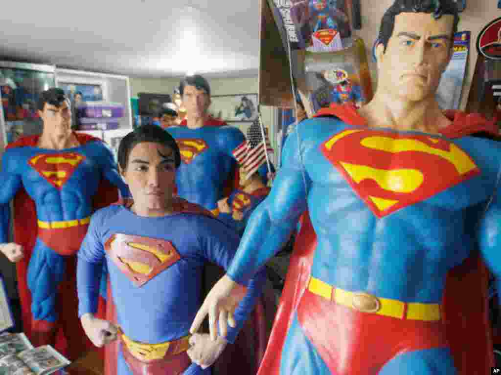 Herbert Chavez poses with his life-sized Superman statues inside his house in Calamba Laguna, south of Manila October 12, 2011. In his idolization of the superhero, Chavez, a self-professed "pageant trainer" who owns two costume stores, has undergone a se