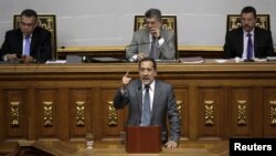 Jose Guerra (C), deputy of the Venezuelan coalition of opposition parties (MUD) and president of the economic special commission, gives a speech during a session of the National Assembly in Caracas, Jan. 22, 2016. 