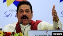 Sri Lankan President Mahinda Rajapaksa gestures as he speaks during a news conference at the Commonwealth Heads of Government Meeting (CHOGM) in Colombo, Nov. 17, 2013. 