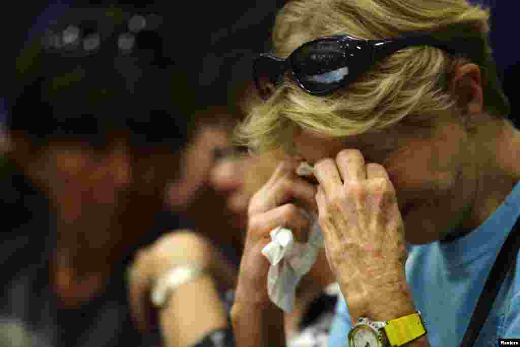 Toni Tennille cries as she listens to Arizona Governor Jan Brewer speak during a news conference at Prescott High School, July 1, 2013.
