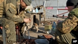 Russia-backed rebels perform weapons maintenance on the outskirts of Debaltseve, Ukraine, March 9, 2015